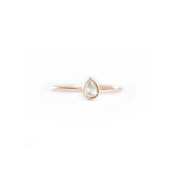 14k gold pear shape diamond engagement ring in bezel set